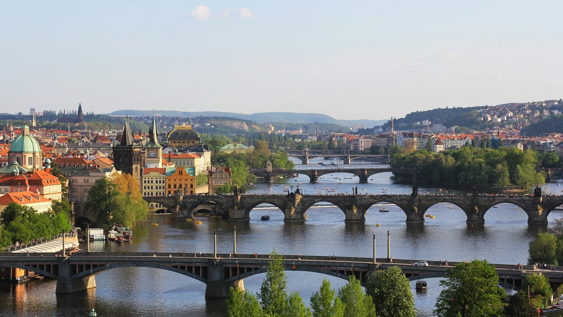 Prague skyline at golden hour with the Vltava river and Charles Bridge